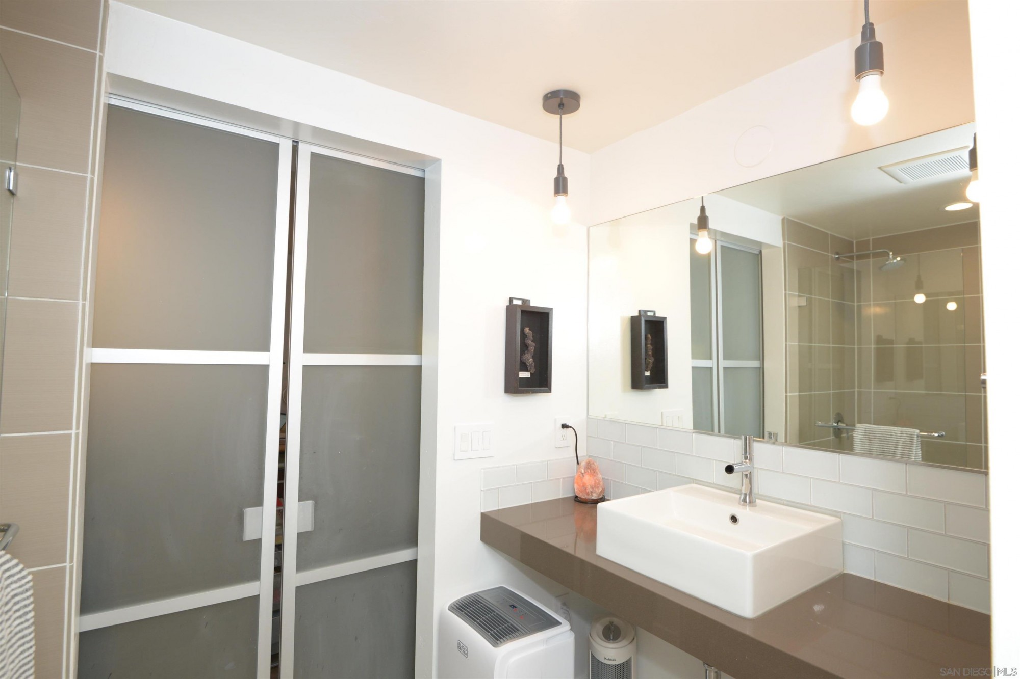 Interior bathroom shot with aluminum frosted doors closed